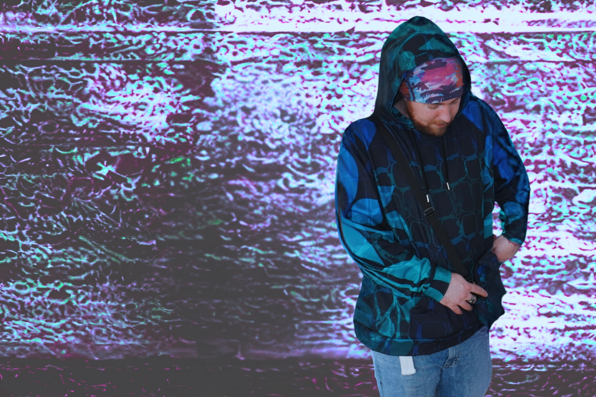 Person in a blue and teal patterned hoodie with a matching side bag, standing against a textured neon background with electric vibes.